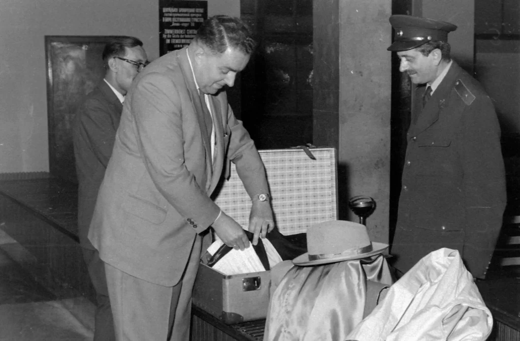 border controller checking the suitcase