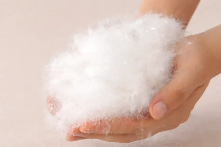 woman holding goose down in hand