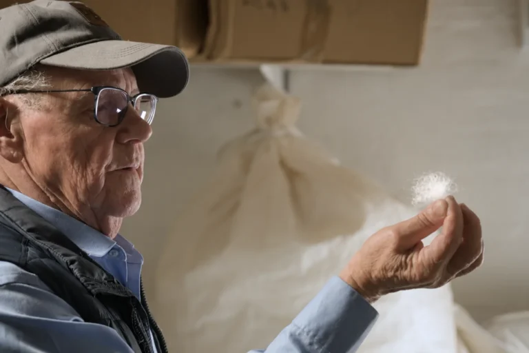 man holding a piece of goose down